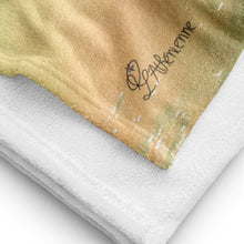 Load image into Gallery viewer, Close-up of Luxurious beach towel inspired by Aegean Sea sailing, featuring nautical design elements and soft, high-quality fabric laid out on a sandy beach