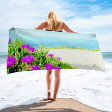 Load image into Gallery viewer, Beach towel inspired by the Violet Ice Plant, featuring vibrant pink floral patterns and soft fabric, styled on a sunny beach setting