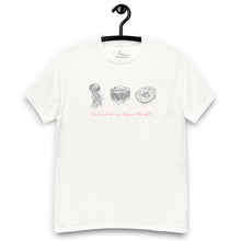 Load image into Gallery viewer, Mockup of a white t-shirt displayed flat, featuring minimalist line art of jellyfish and the phrase &#39;Floating like an Aegean thought&#39; on the front
