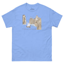 Load image into Gallery viewer, Carolina blue unisex T-shirt featuring artwork inspired by Homer's Odyssey Episode X, depicting Odysseus' ship trapped between towering cliffs and the giant Laestrygonians with the word Trapped beneath the illustration.
