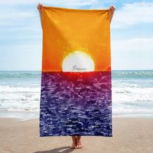 Load image into Gallery viewer, Elegant beach towel inspired by an Aegean Sea sunrise, featuring warm sunset tones and soft premium fabric laid on the sand
