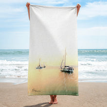 Load image into Gallery viewer, Luxurious beach towel inspired by Aegean Sea sailing, featuring nautical design elements and soft, high-quality fabric laid out on a sandy beach
