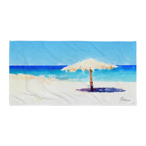 Cozy beach towel inspired by a secluded Greek beach, styled under an umbrella on a quiet, sandy shoreline